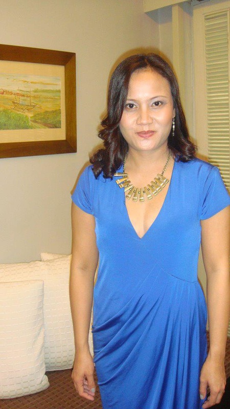 Rona in a royal blue draped jersey dress